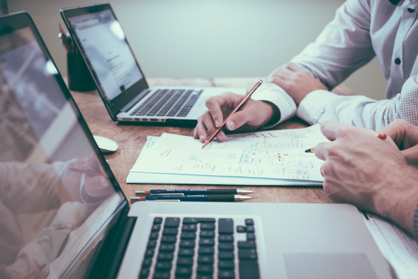 Two people reviewing plans and analytics at a desk